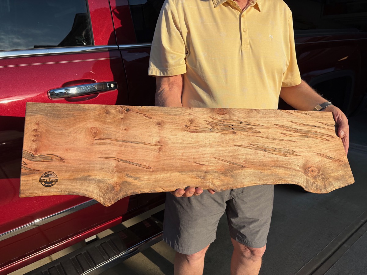 Steve holding a live-edge serving board